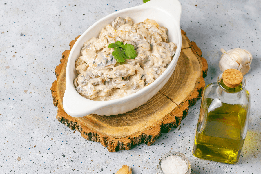 A baking dish filled with savory chicken dressing, topped with golden breadcrumbs, and garnished with fresh herbs.